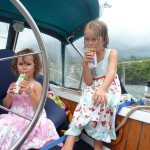 Pacific sailor girls enjoy a celebetory juice (after a rain shower!) in Atuona, Hiva Oa